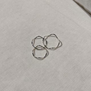 three Overlapping silver wave rings