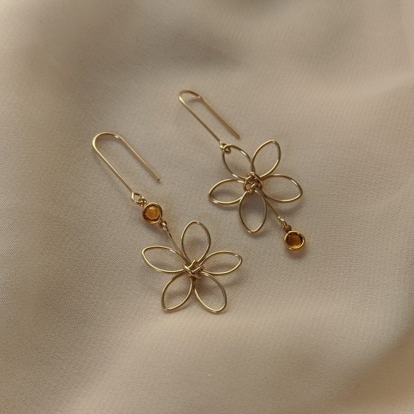 Gold flora earrings with yellow gem