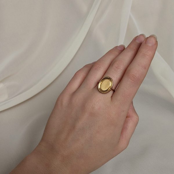 gold portrait ring on hand