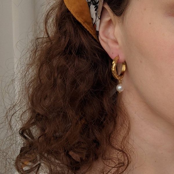 gold heirloom earrings on ears